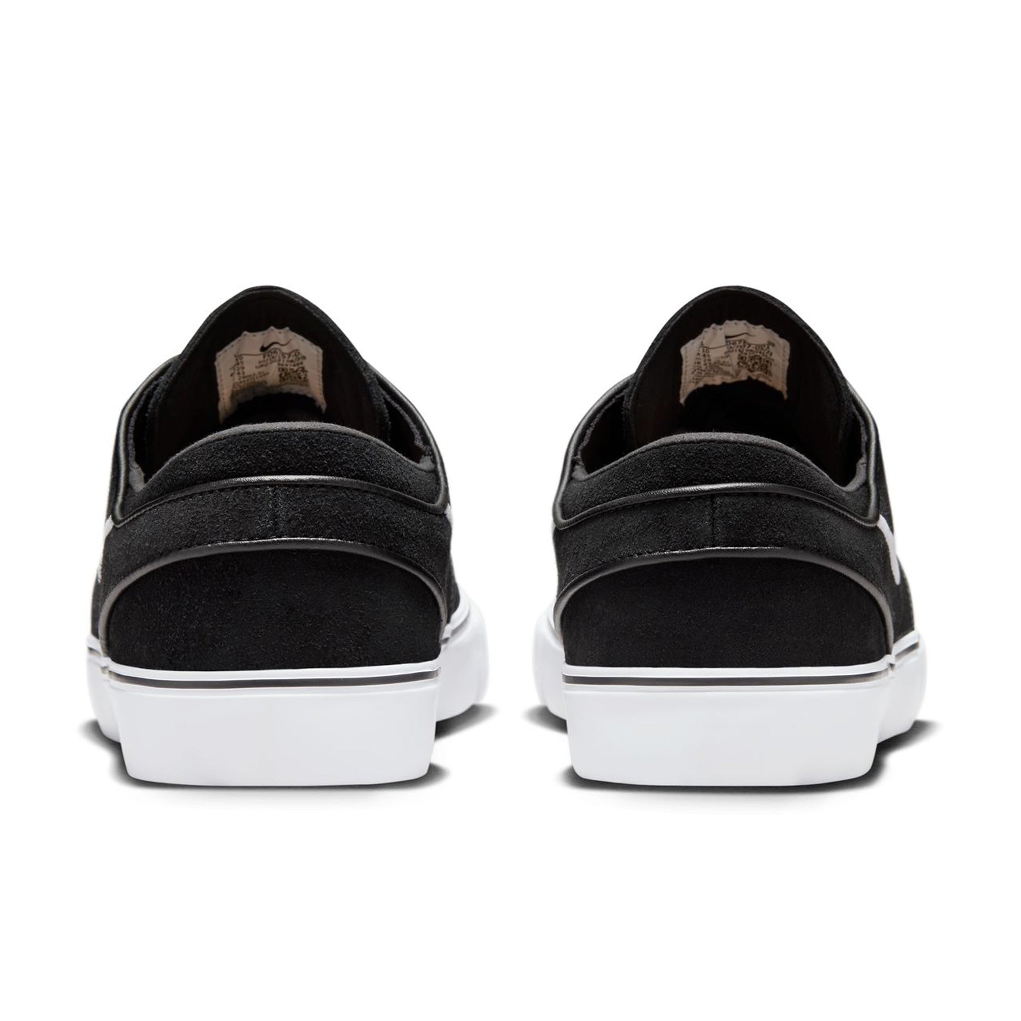 Low top Nike SB janoski skate shoes, in black and white colourway with white nike swoosh on sides.
