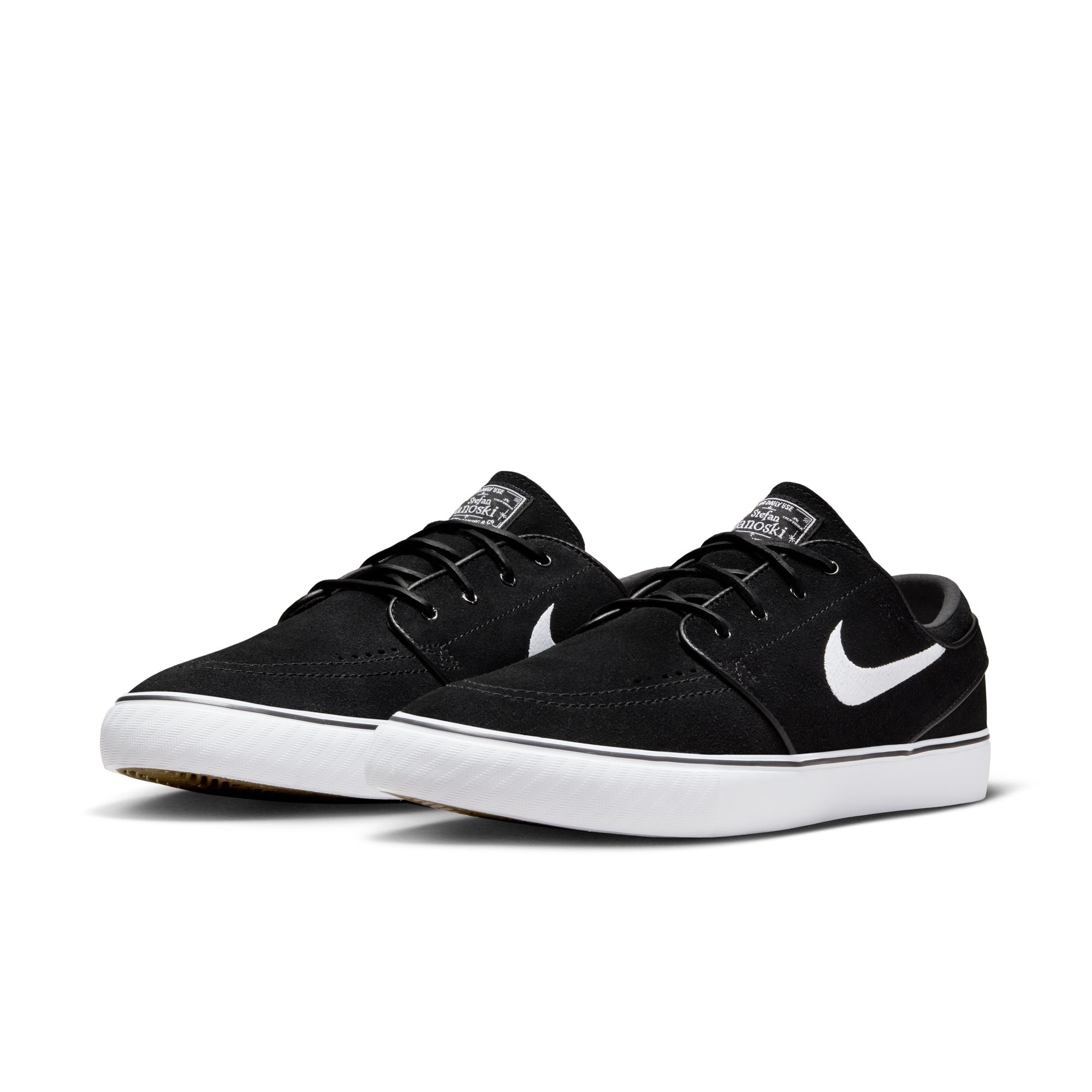 Low top Nike SB janoski skate shoes, in black and white colourway with white nike swoosh on sides.