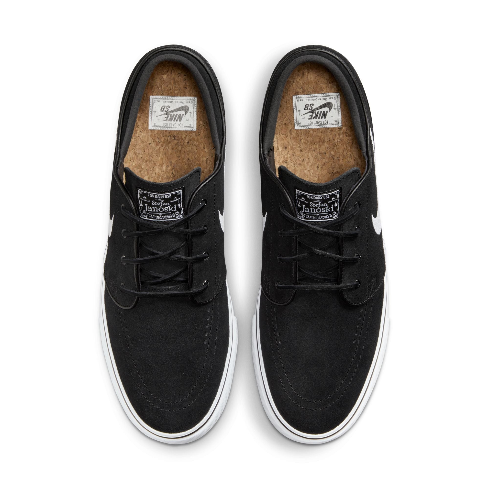 Low top Nike SB janoski skate shoes, in black and white colourway with white nike swoosh on sides.