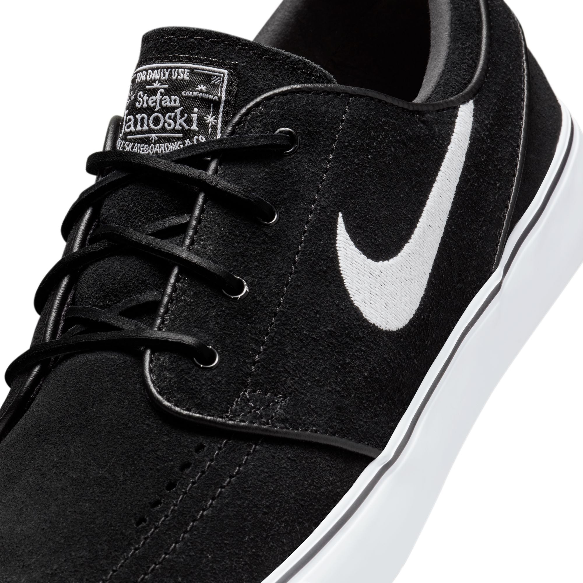 Low top Nike SB janoski skate shoes, in black and white colourway with white nike swoosh on sides.