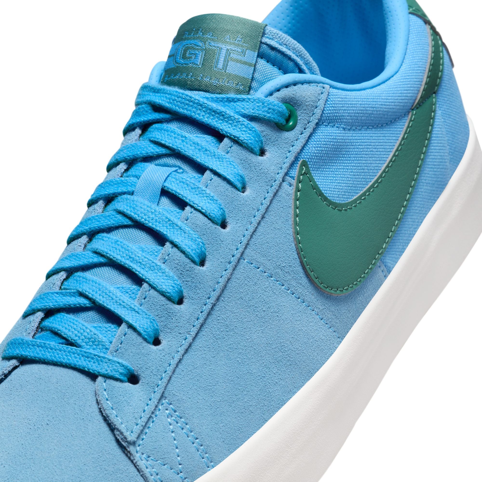 University blue nike sb blazer low top shoes with teal nike tick and white sole. Free uk shipping over £50