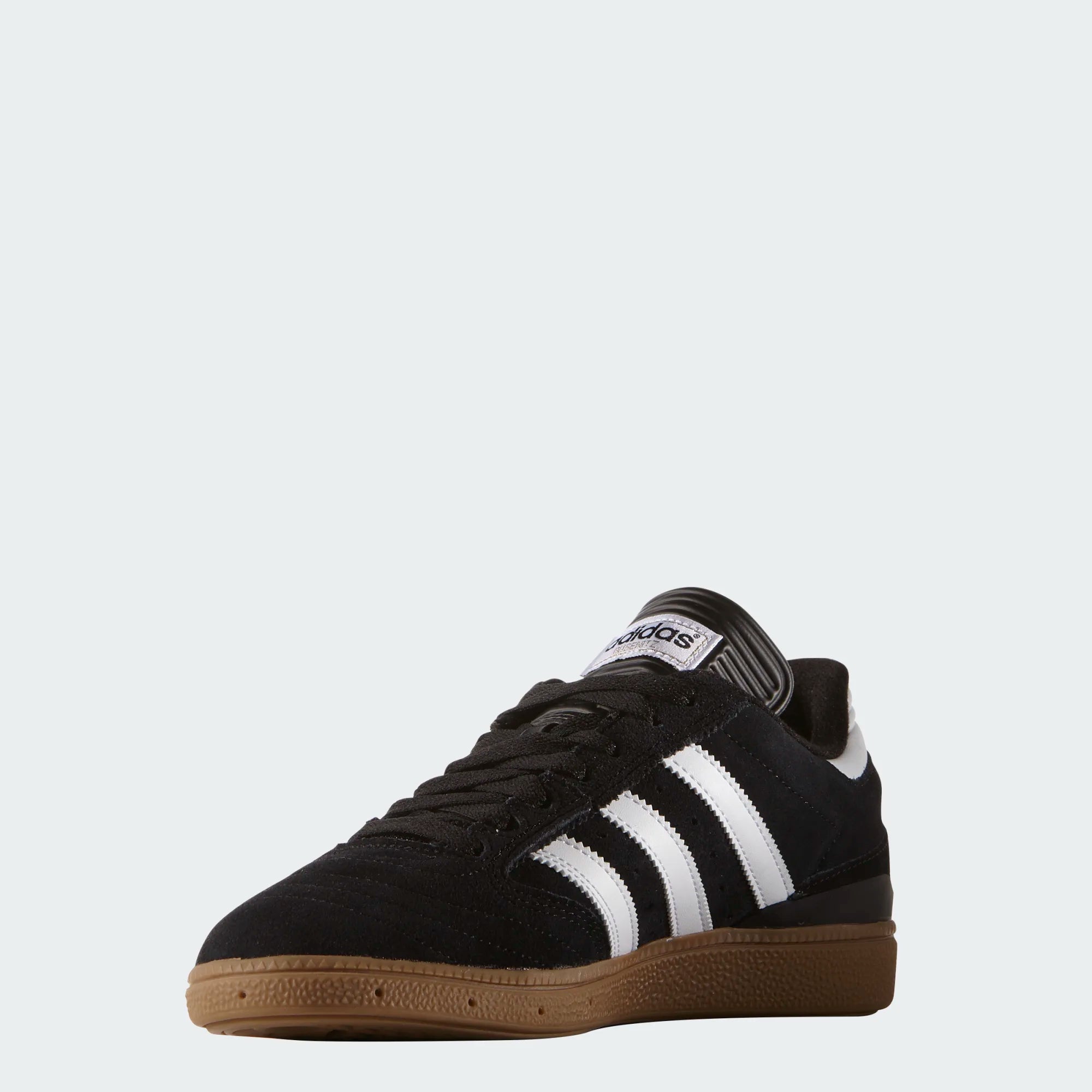 Black Adidas sneaker with white stripes on a light gray background