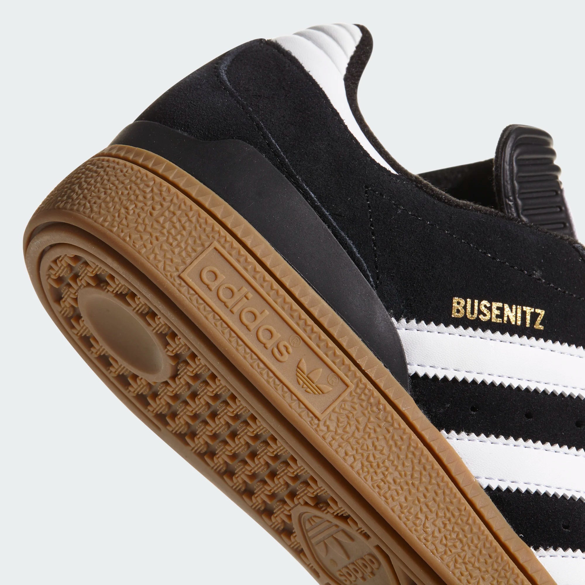 Close-up of an Adidas Busesenitz sneaker with a focus on the sole and brand logo.