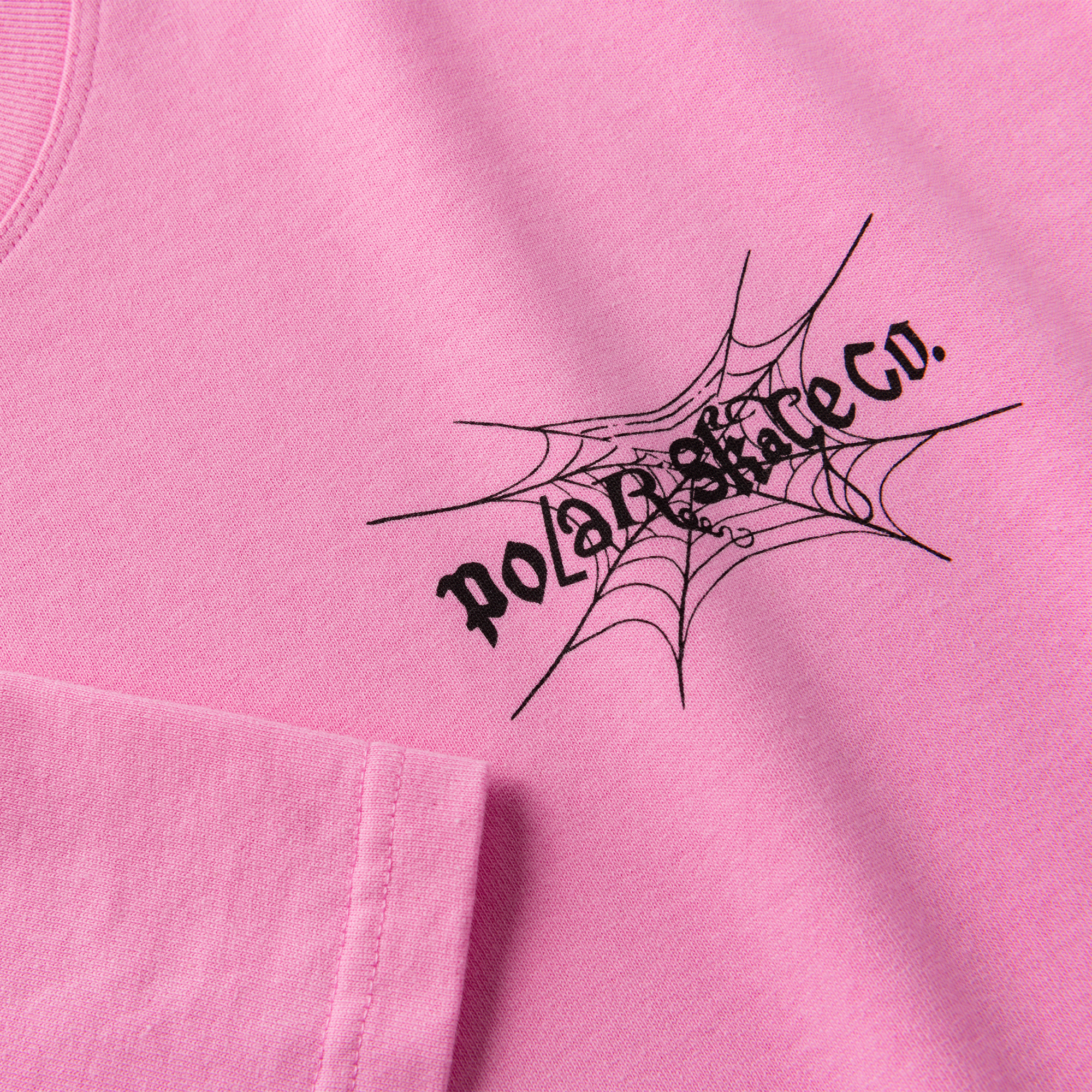 Pink polar short sleeve T-shirt with black spiderweb logo on front. Free uk shipping on orders over £50