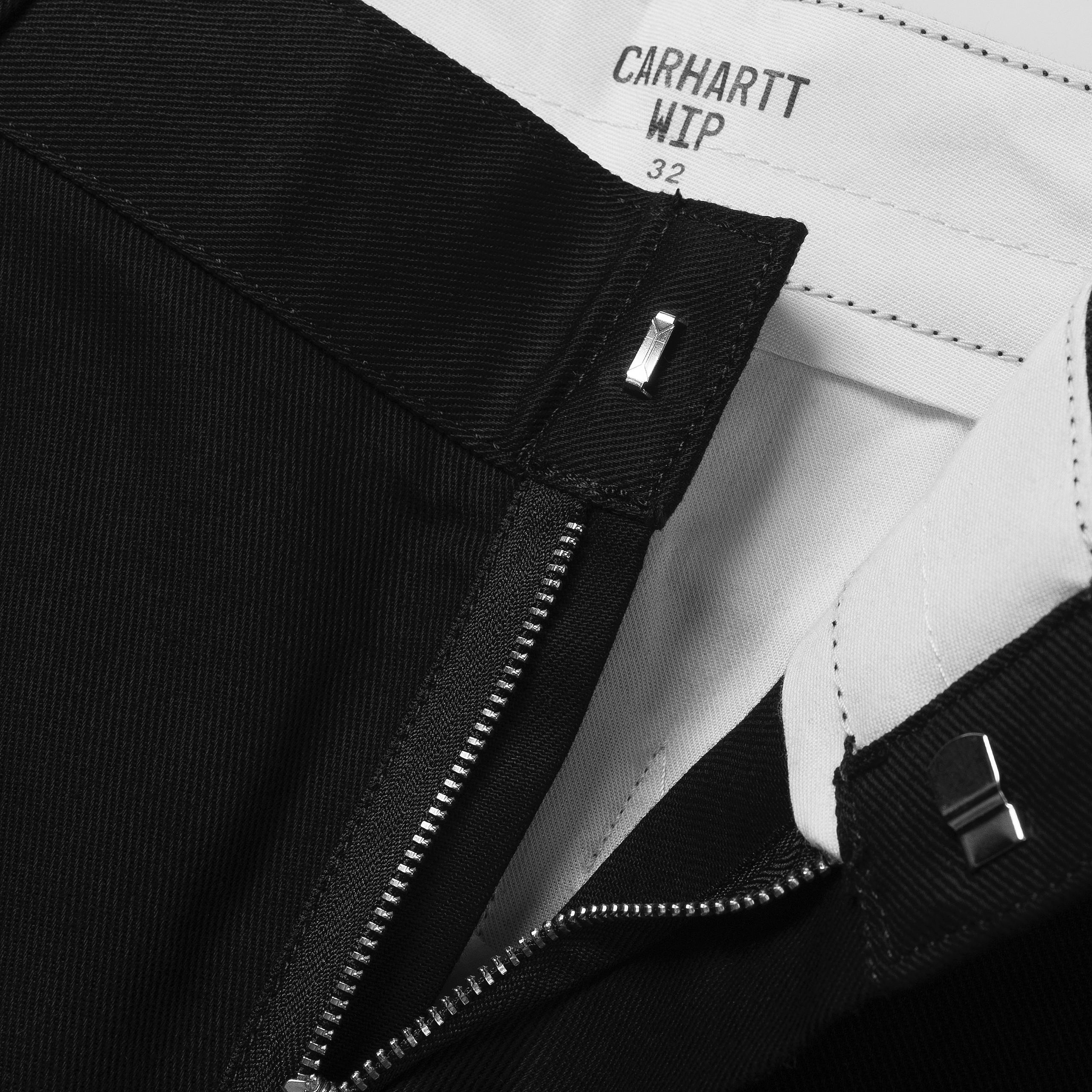 Black Carhartt craft pants with woven logo. Free UK shipping on orders over £50.