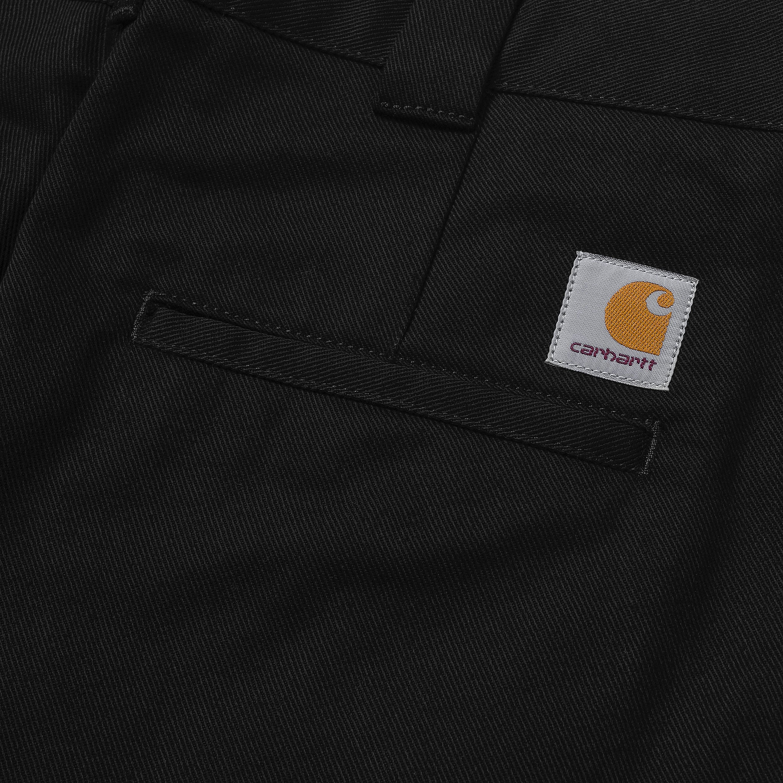 Black Carhartt craft pants with woven logo. Free UK shipping on orders over £50.