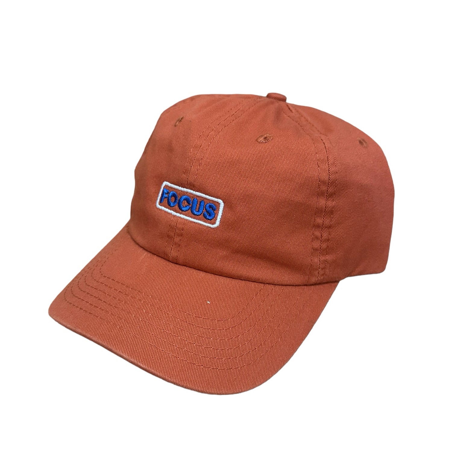 Pumpkin orange focus 6 panel cap with white and blue focus logo on front. Free uk shipping over £50