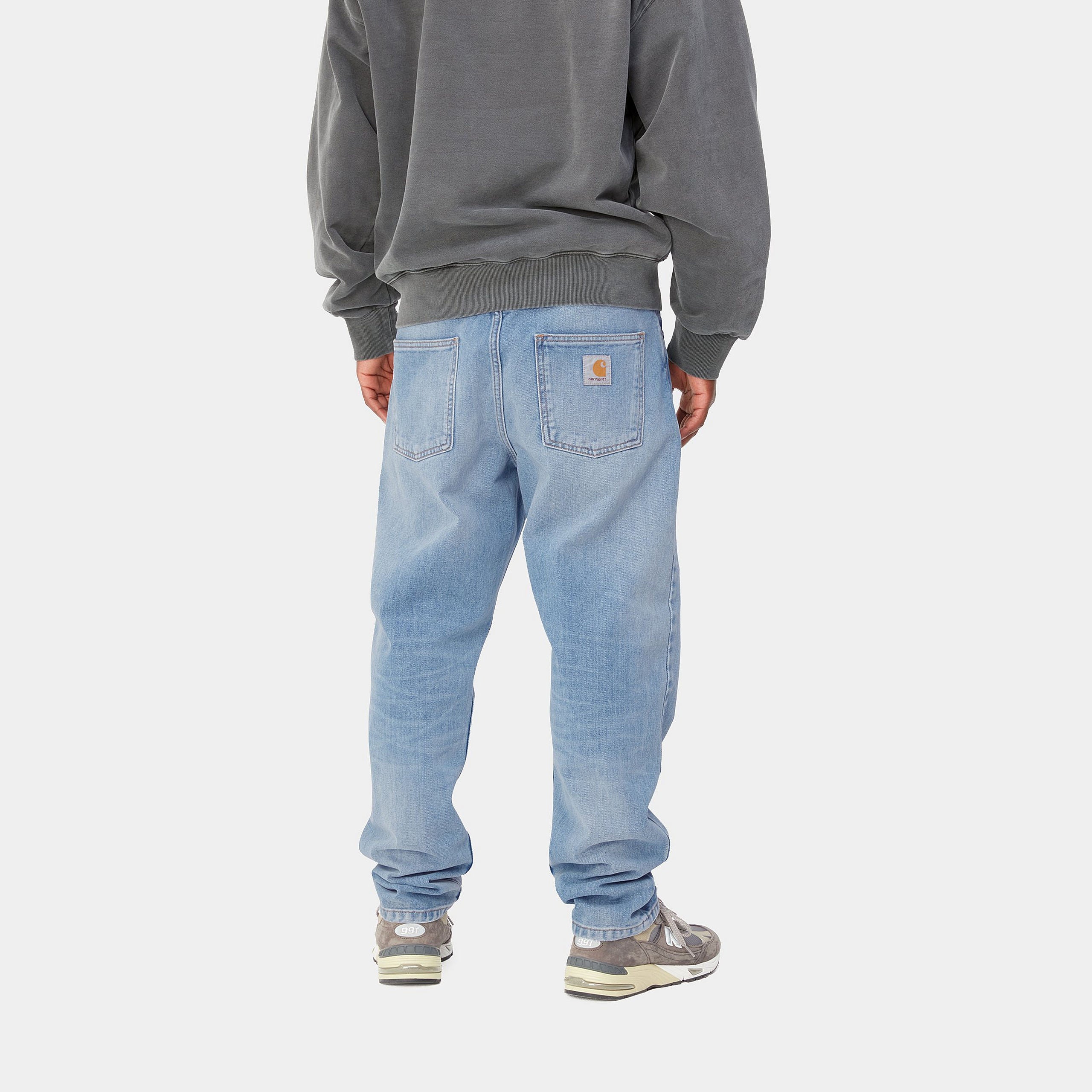 Light blue denim Carhartt trousers with woven logo on back pocket. Free UK shipping on orders over £50.