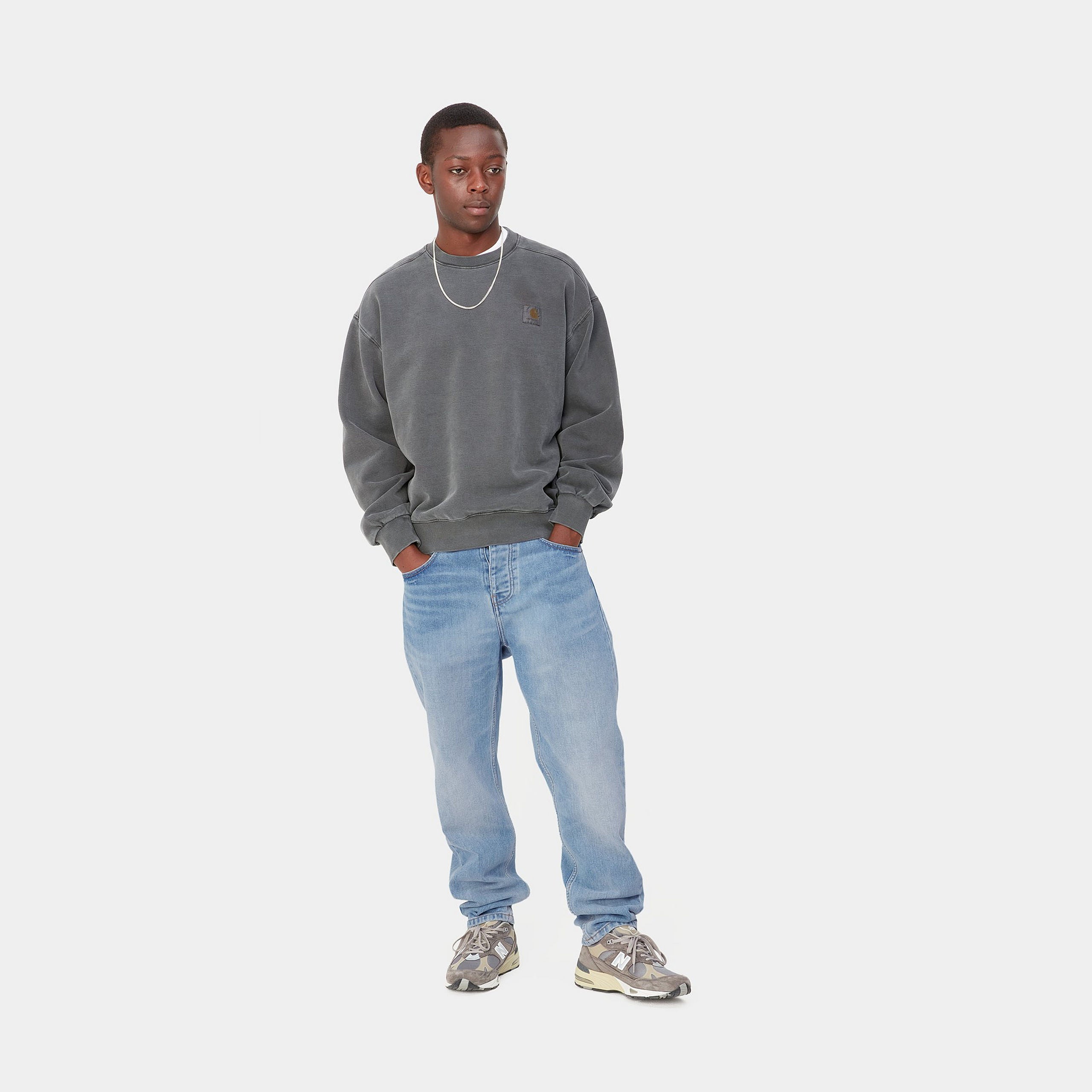 Light blue denim Carhartt trousers with woven logo on back pocket. Free UK shipping on orders over £50.