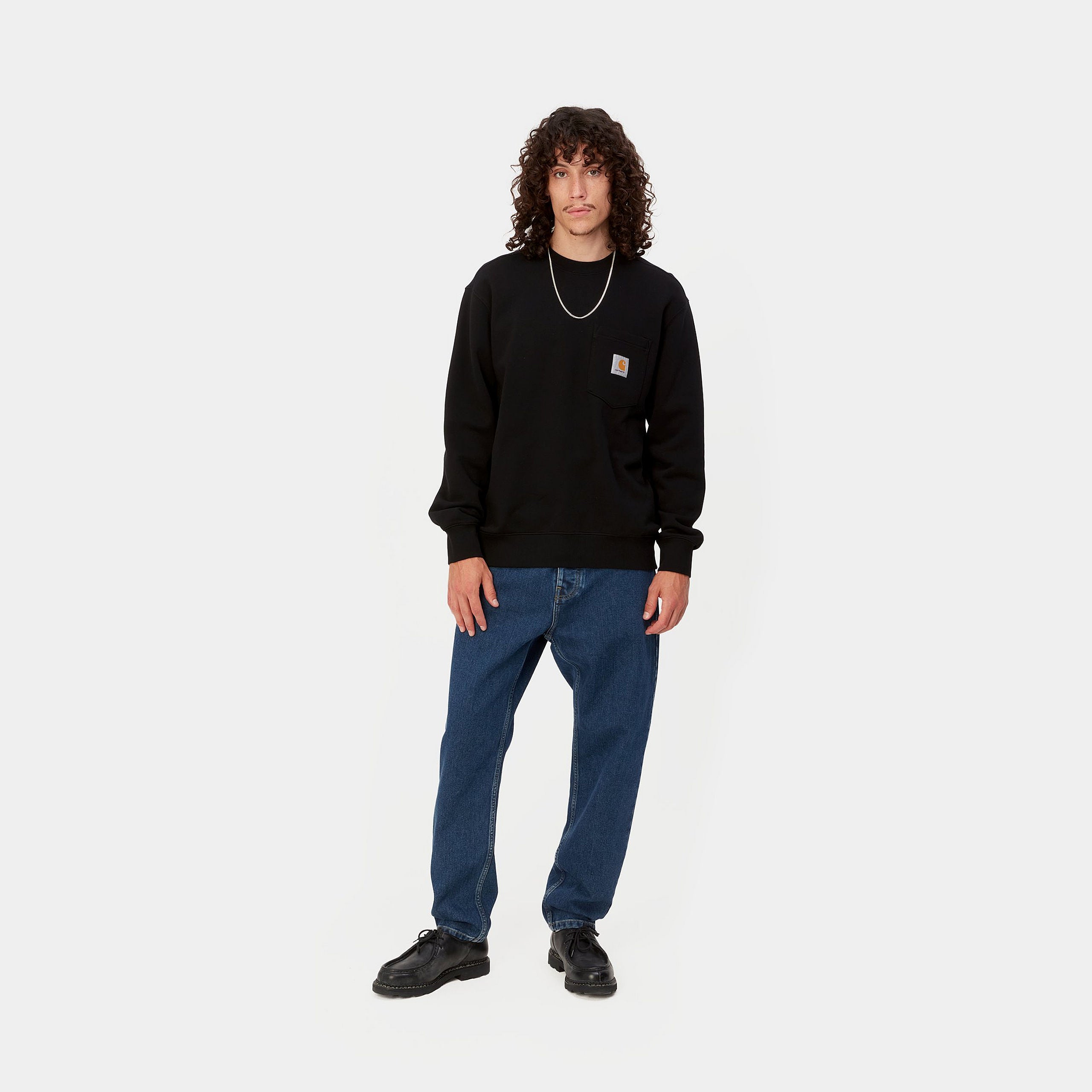 Dark blue denim Carhartt trousers with woven logo on back pocket. Free UK shipping on orders over £50.