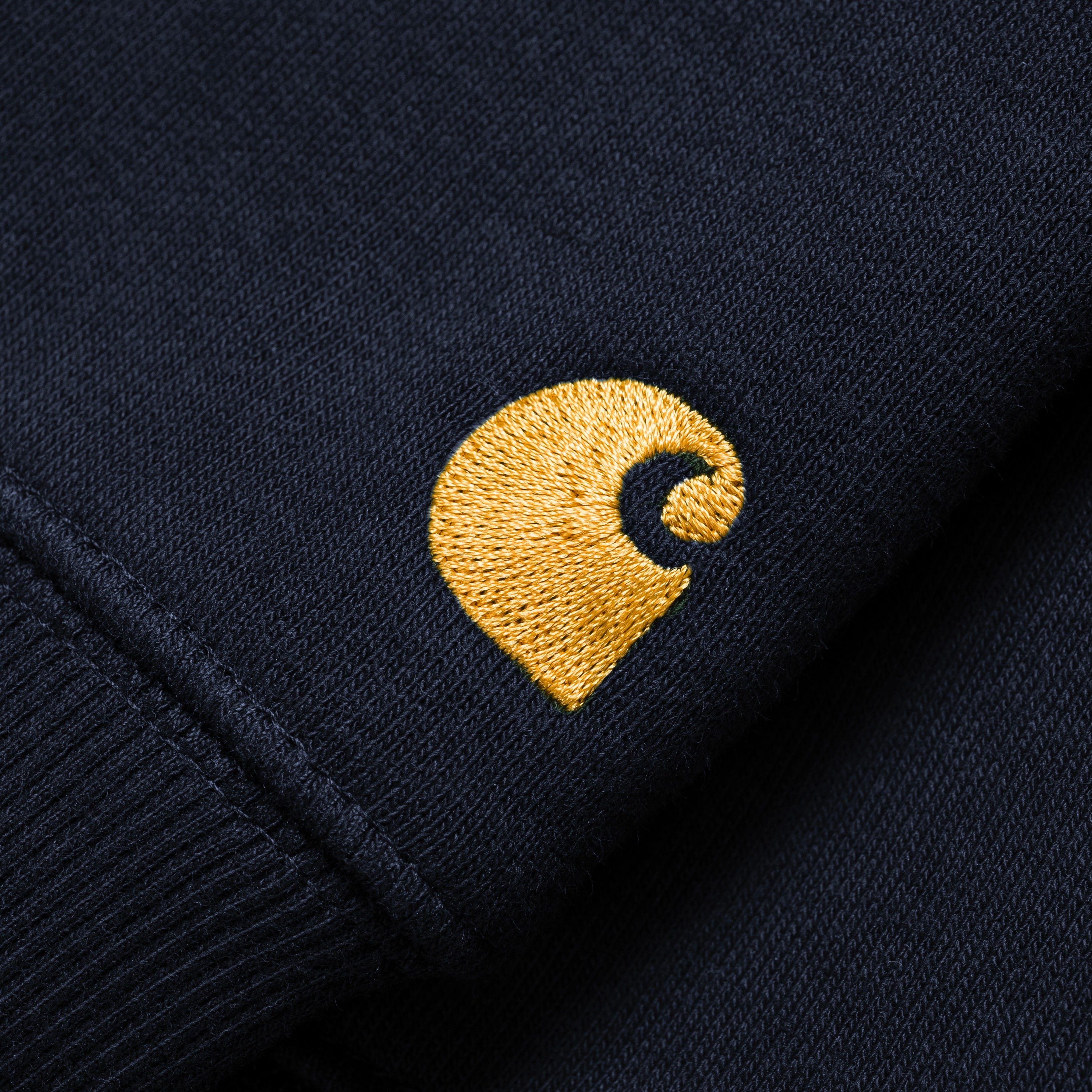 Black Carhartt chase sweatshirt with gold embroidered logo. Free UK shipping on orders over £50.