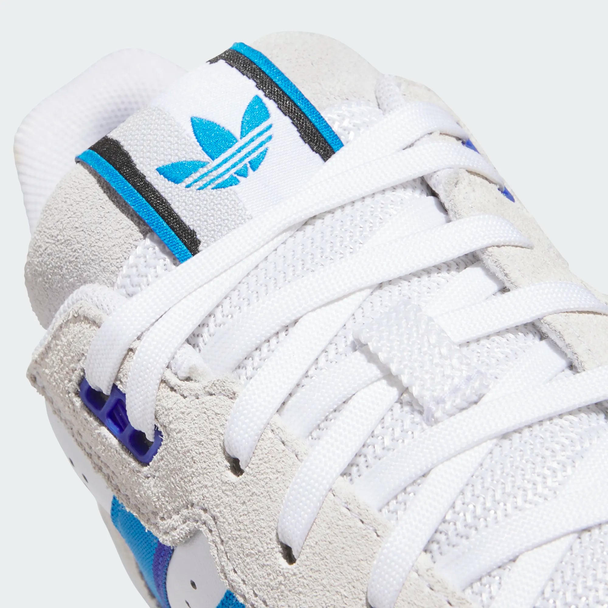 White Adidas skateboarding shoe with blue accents on a white background