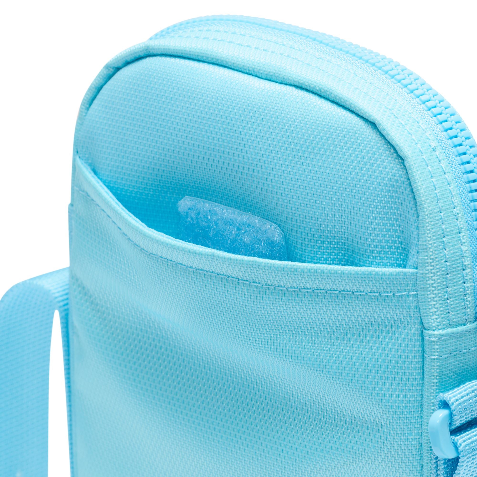Light blue nike crossbody bag with mesh front pocket and white nike swoosh logo. Free uk shipping over £50