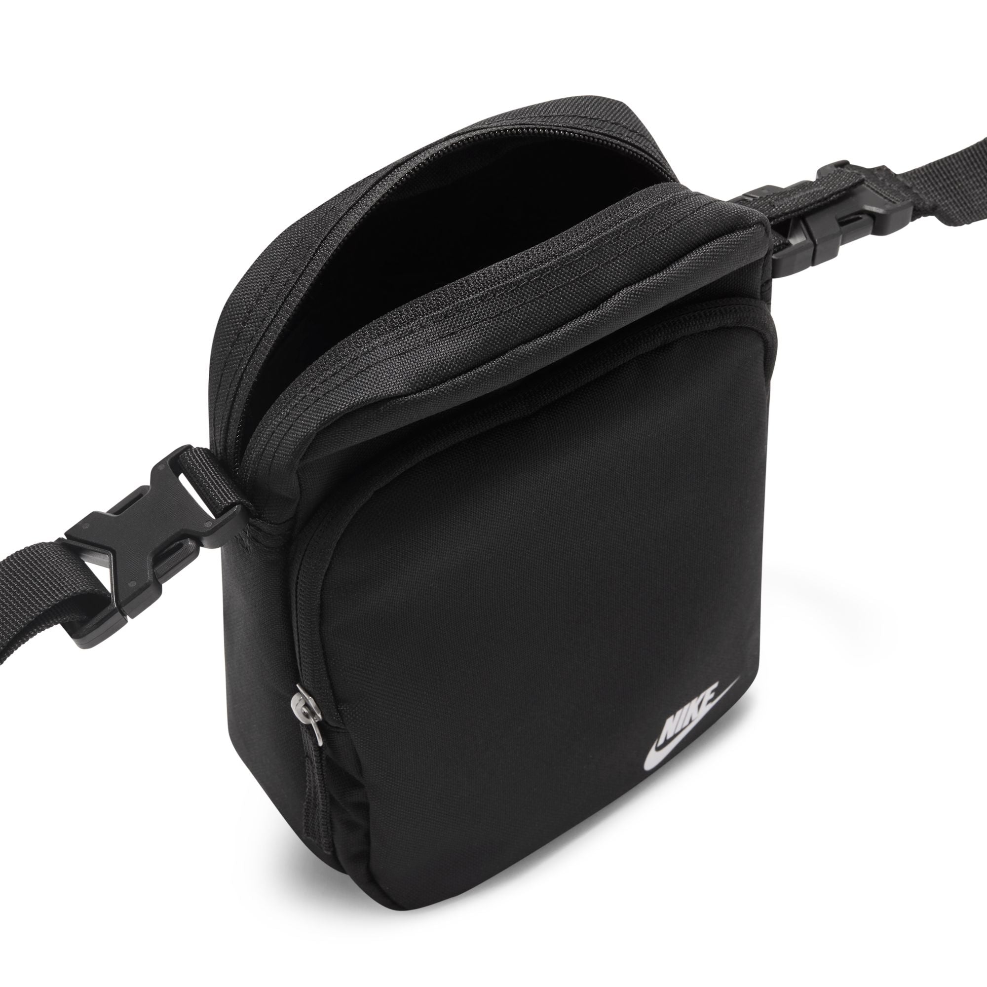 Black Nike heritage shoulder bag with small white Nike logo on front. Features two separate zipped compartments