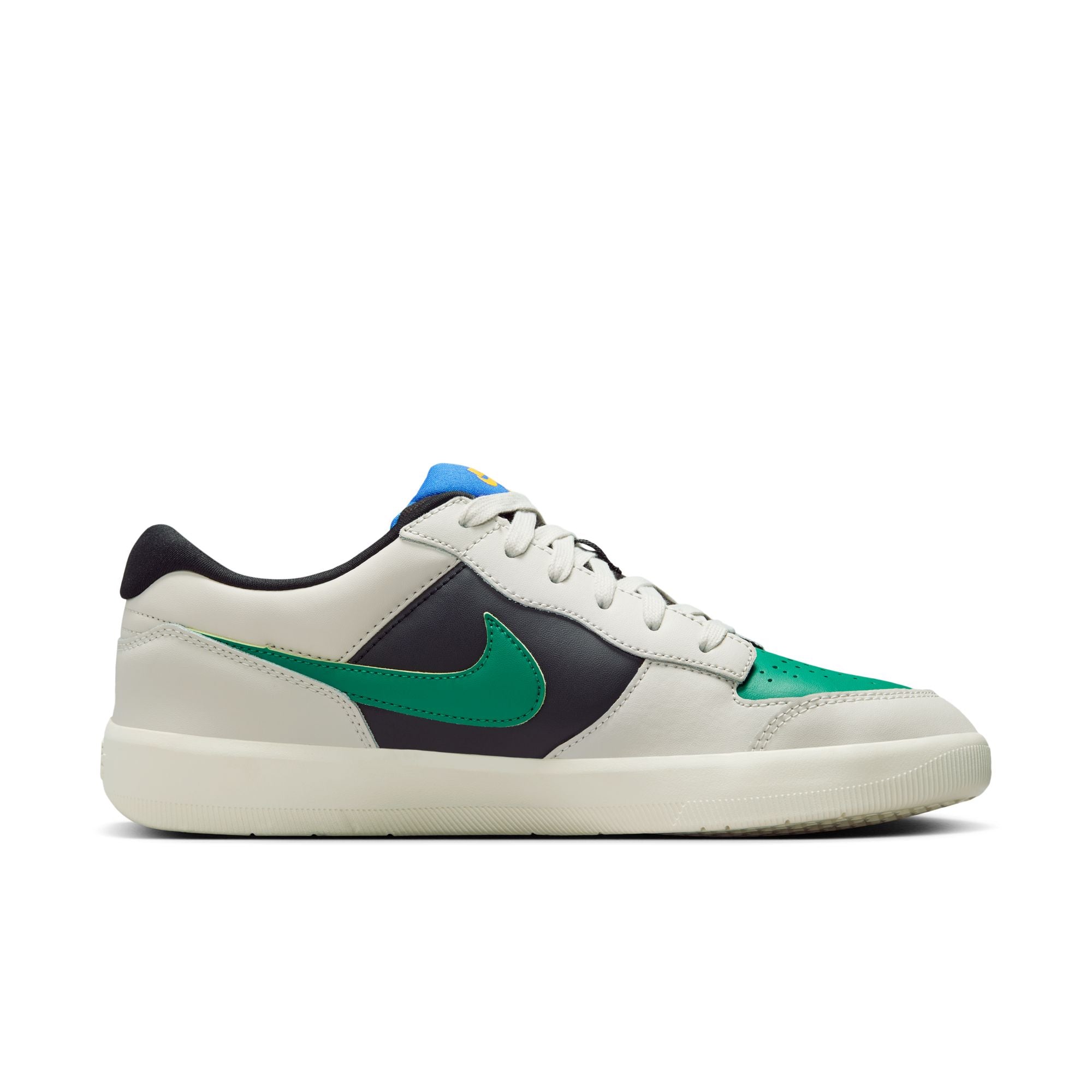 Low top Nike SB Force 58 Premium skate shoes, in light grey, black and green colourway, with blue and yellow accents on tongue and green Nike swoosh on sides.