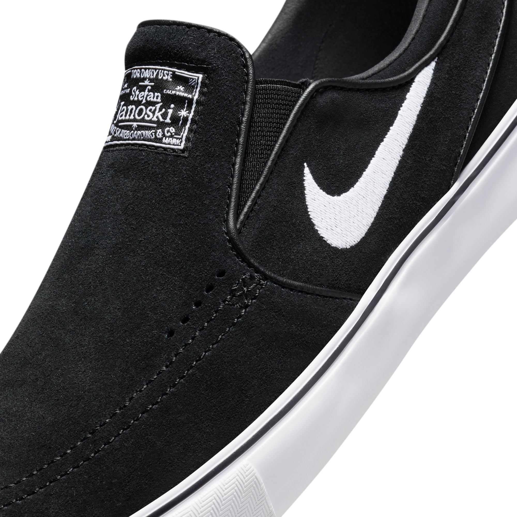 Black and white nike slip ons hotsell