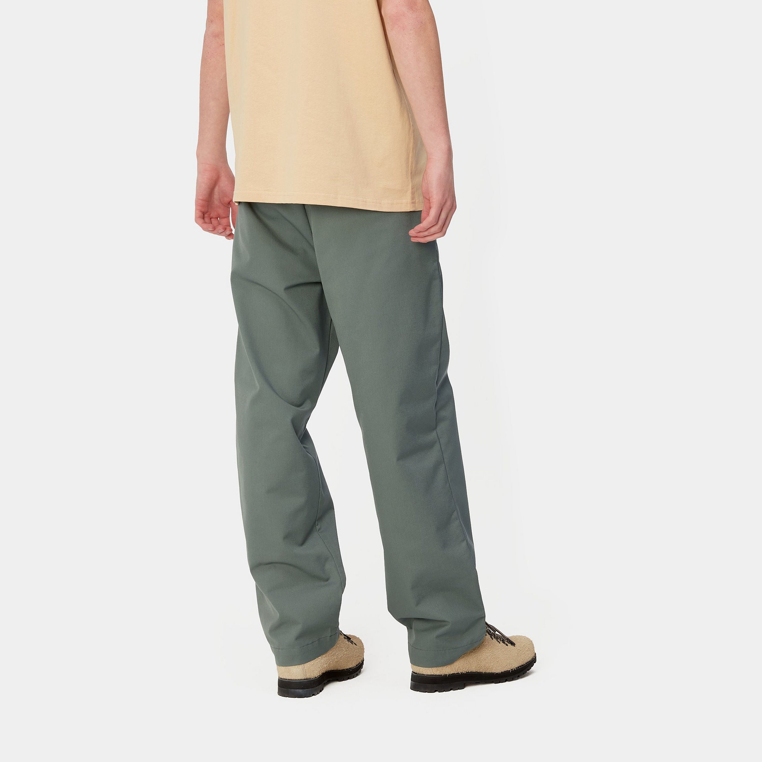 Light green Carhartt craft pants with woven logo. Free UK shipping on orders over £50.