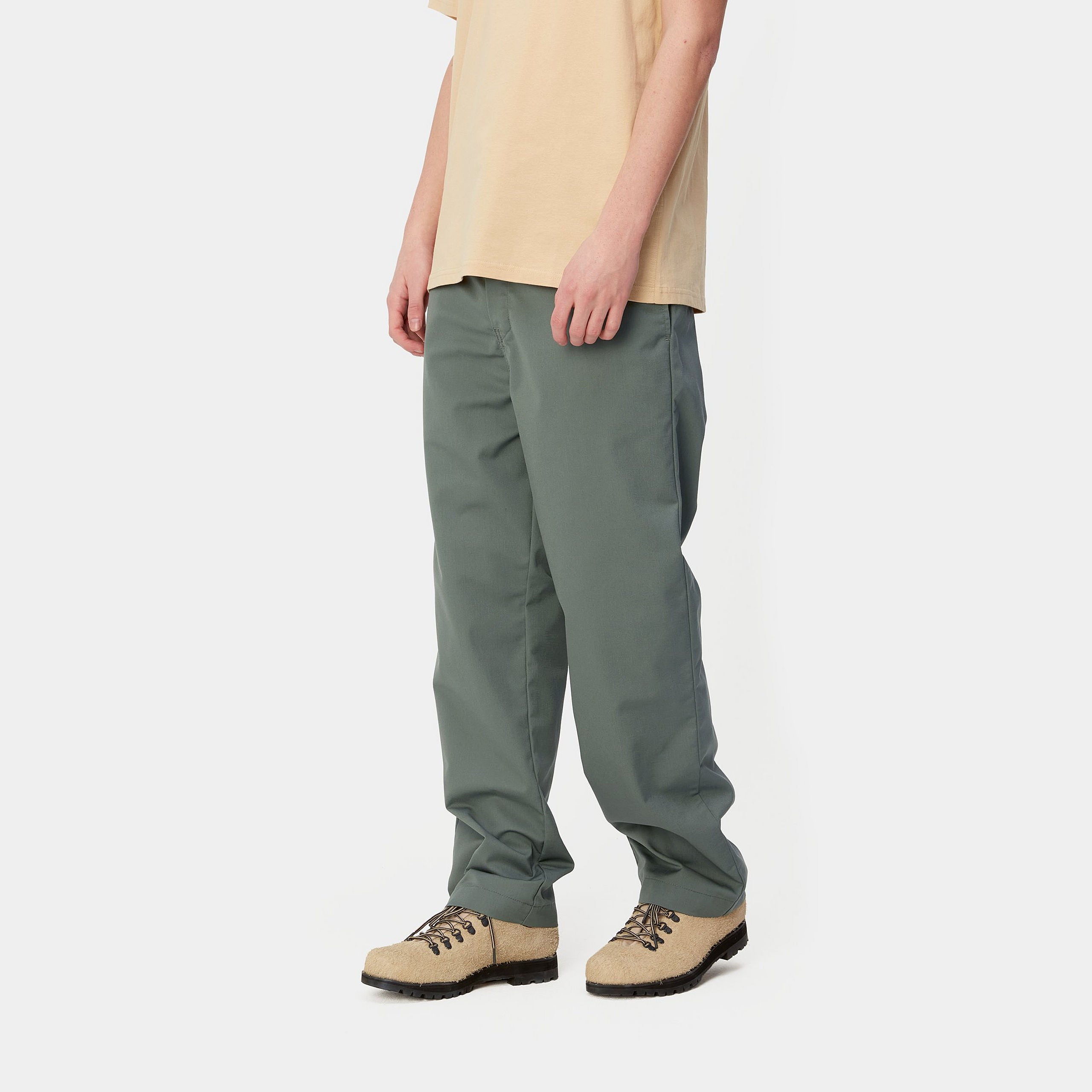 Light green Carhartt craft pants with woven logo. Free UK shipping on orders over £50.