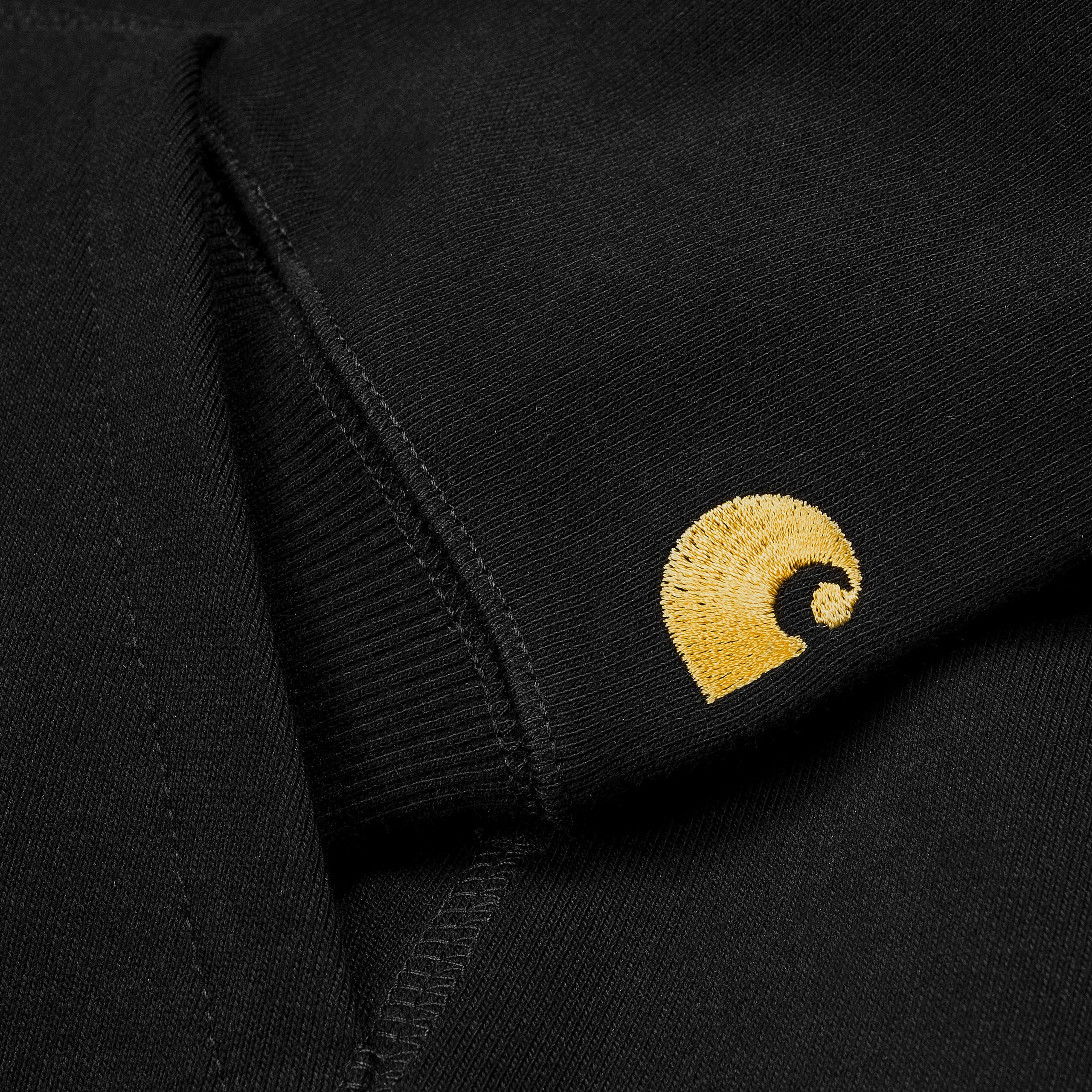 Black Carhartt hoodie with gold embroidered logo on sleeve. Free UK shipping on orders over £50.